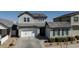 Charming two-story home with a two car garage, a well-kept lawn and an American flag at 22752 E Arroyo Verde Dr, Queen Creek, AZ 85142