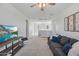 Comfortable living room with plush sofa, media console, and ample space, perfect for relaxation and entertainment at 22752 E Arroyo Verde Dr, Queen Creek, AZ 85142