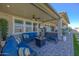 Relax on the covered patio with a cozy fire pit and comfortable seating at 22752 E Arroyo Verde Dr, Queen Creek, AZ 85142