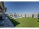 A large swimming pool is surrounded by lush green turf at 22752 E Arroyo Verde Dr, Queen Creek, AZ 85142