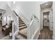 Carpeted staircase with bright white railings and view into a clean and modern powder room at 22752 E Arroyo Verde Dr, Queen Creek, AZ 85142