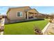 Backyard featuring lush artificial turf, covered patio, and privacy wall at 24738 N 175Th Ave, Surprise, AZ 85387