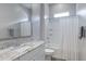 Bright bathroom with white cabinets, granite countertop, and shower-tub combination with white tile surround at 24738 N 175Th Ave, Surprise, AZ 85387