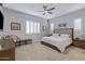 Spacious bedroom featuring neutral tones, a ceiling fan, plantation shutters, and carpet flooring at 24738 N 175Th Ave, Surprise, AZ 85387