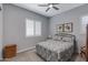 Inviting bedroom featuring a comfortable bed with patterned bedding and natural light at 24738 N 175Th Ave, Surprise, AZ 85387