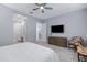 Comfortable bedroom featuring a ceiling fan, television, and connecting bathroom at 24738 N 175Th Ave, Surprise, AZ 85387
