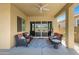 Cozy covered patio with comfortable seating and ceiling fan, perfect for outdoor enjoyment at 24738 N 175Th Ave, Surprise, AZ 85387