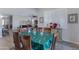 Charming dining area with wood chairs and view of adjoining living space with many windows at 24738 N 175Th Ave, Surprise, AZ 85387