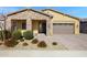 Inviting single-story home featuring a stone facade and a well-maintained desert landscape in the front yard at 24738 N 175Th Ave, Surprise, AZ 85387