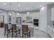Modern kitchen boasts white cabinets, granite countertops, stainless steel appliances, and an island with seating at 24738 N 175Th Ave, Surprise, AZ 85387