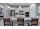 Modern kitchen with stainless steel appliances, granite countertops, white cabinets, and an island with seating at 24738 N 175Th Ave, Surprise, AZ 85387