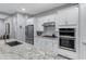 Contemporary kitchen featuring stainless steel appliances, granite countertops, white cabinets and a large island at 24738 N 175Th Ave, Surprise, AZ 85387