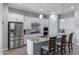 Bright kitchen with stainless steel appliances, a large island featuring seating, and white cabinets at 24738 N 175Th Ave, Surprise, AZ 85387