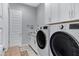 Functional laundry room with modern washer/dryer and ample cabinet space for storage at 24738 N 175Th Ave, Surprise, AZ 85387