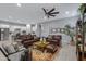 Expansive living room with open floor plan, sleek flooring, and comfortable leather seating at 24738 N 175Th Ave, Surprise, AZ 85387