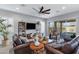 Open living space with tile floors, sliding glass doors to the patio, and leather sofas at 24738 N 175Th Ave, Surprise, AZ 85387