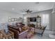 Spacious living room features wood-look flooring, recessed lighting, and leather furnishings at 24738 N 175Th Ave, Surprise, AZ 85387