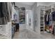 Spacious walk-in closet with custom shelving, ample storage, and carpet flooring at 24738 N 175Th Ave, Surprise, AZ 85387