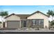 Charming single-story home featuring a gray garage door and stone accents at 2554 E Tepenade Dr, San Tan Valley, AZ 85140