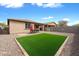 Spacious backyard features rock landscaping, an artificial lawn and a brick wall at 35730 N Pommel Pl, San Tan Valley, AZ 85144