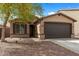 Charming single-story home featuring a low-maintenance front yard and a two-car garage at 35730 N Pommel Pl, San Tan Valley, AZ 85144