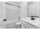 Clean bathroom with white vanity, bathtub, shower, and white marble style surround at 3746 S 234Th Ln, Buckeye, AZ 85326