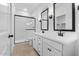 Contemporary bathroom with a dual sink vanity, black fixtures, and a glass shower enclosure at 3746 S 234Th Ln, Buckeye, AZ 85326