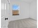 Bright bedroom featuring carpet floors, a window with blinds, and a white door at 3746 S 234Th Ln, Buckeye, AZ 85326