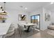 Dining room with a modern table, six chairs, stylish decor, and a sliding glass door at 3746 S 234Th Ln, Buckeye, AZ 85326