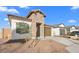 Charming home showcasing a stone accent wall, desert landscaping, and an attached two-car garage at 3746 S 234Th Ln, Buckeye, AZ 85326