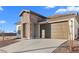 Beautiful home boasting a stone accent wall, brown garage door, and meticulously maintained landscaping at 3746 S 234Th Ln, Buckeye, AZ 85326