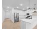 Contemporary kitchen with white cabinets, stainless steel appliances, and a breakfast bar for dining at 3746 S 234Th Ln, Buckeye, AZ 85326