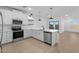 Modern kitchen featuring stainless steel appliances, sleek countertops, and an open layout at 3746 S 234Th Ln, Buckeye, AZ 85326