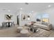 Bright living room featuring a comfortable sofa, stylish decor, and a modern dining area at 3746 S 234Th Ln, Buckeye, AZ 85326