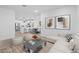 Open concept living room with view of the kitchen, dining area, and modern decor at 3746 S 234Th Ln, Buckeye, AZ 85326