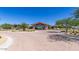 Community clubhouse with a grand entrance, brick paving, and desert landscaping at 39801 N Trajen Pl, San Tan Valley, AZ 85140