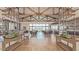 Clubhouse interior featuring high ceilings, wood beams, tile flooring, and seating areas at 39801 N Trajen Pl, San Tan Valley, AZ 85140