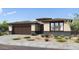 Single-story home with a brown garage, desert landscaping, and a neutral-colored facade at 39801 N Trajen Pl, San Tan Valley, AZ 85140