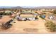 Aerial shot featuring a home, RV parking, a green car, and horse facilities in a desert landscape at 404 W Galvin St, Phoenix, AZ 85086