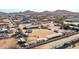 An aerial view of the property with a riding area, horse facilities, and a spacious house at 404 W Galvin St, Phoenix, AZ 85086
