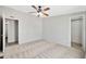 Bedroom features carpeted floors, ceiling fan and a connected walk-in closet at 404 W Galvin St, Phoenix, AZ 85086