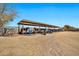 View of horse facilities with covered stalls and horses inside at 404 W Galvin St, Phoenix, AZ 85086