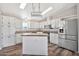 Bright kitchen features white cabinets, stainless steel appliances, and a skylight at 404 W Galvin St, Phoenix, AZ 85086
