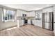 Bright kitchen with stainless steel appliances, white cabinetry, and wood-look flooring at 404 W Galvin St, Phoenix, AZ 85086