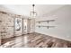 Living room with brick accent wall, wood floors and natural light at 404 W Galvin St, Phoenix, AZ 85086