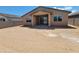 A spacious dirt backyard enclosed by block walls, with a covered patio, perfect for entertaining at 4332 W Hannah St, San Tan Valley, AZ 85144