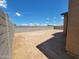 A spacious dirt backyard enclosed by block walls, ready for landscaping and outdoor activities at 4332 W Hannah St, San Tan Valley, AZ 85144