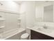 Well-lit bathroom features a shower-tub combo, toilet, and a vanity with a white countertop and a dark brown cabinet at 4332 W Hannah St, San Tan Valley, AZ 85144