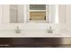 Bathroom vanity featuring double sinks, dark cabinets, white countertops, and a large mirror at 4332 W Hannah St, San Tan Valley, AZ 85144