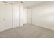 Carpeted bedroom with sliding closet doors and a doorway to another room at 4332 W Hannah St, San Tan Valley, AZ 85144